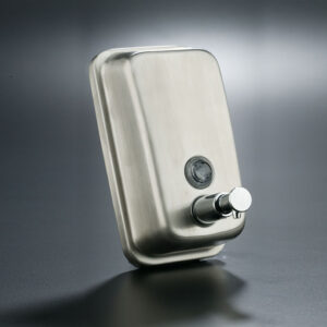Vertical soap dispenser in satin stainless steel with 0.5-liter tank, manual valve, viewing window, and key lock for professional environments.